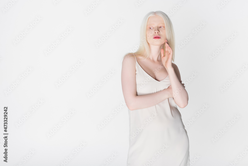 Trendy albino woman looking away isolated on white. Trendy albino woman looking away isolated on white.