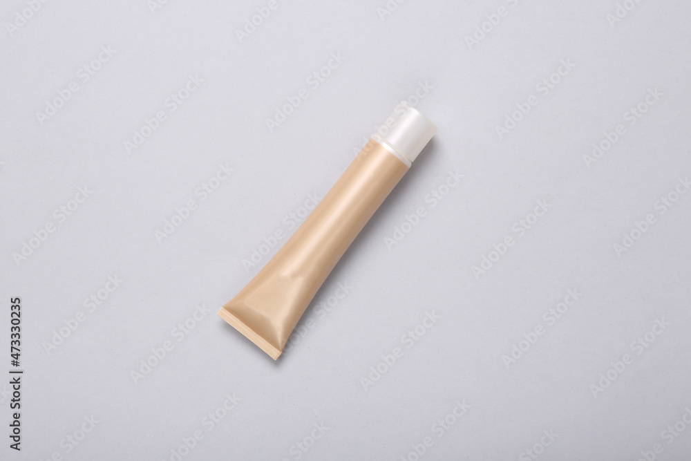 Tube of foundation on gray background. Top view Tube of foundation on gray background. Top view