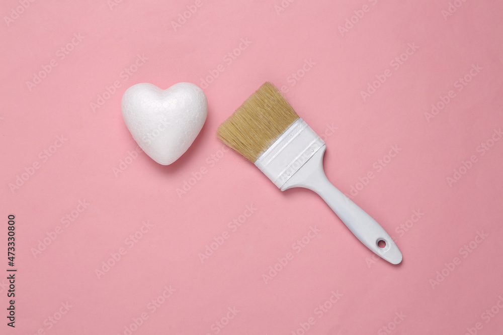 Brush with an unpainted white heart on a pink background. Valentine's day, love concept. Top view Brush with an unpainted white heart on a pink background. Valentine's day, love concept. Top view