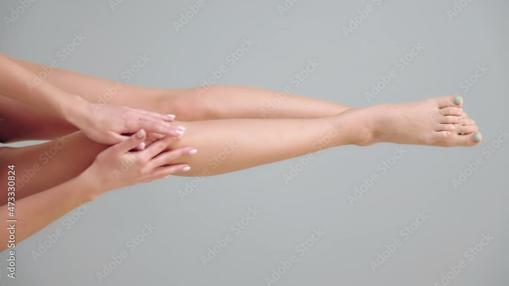 Slender sexy woman showing elegantly smooth legs. Copy space. Vertical orientation. The concept of epilation and hair removal Slender sexy woman showing elegantly smooth legs. Copy space. Vertical orientation. The concept of epilation and hair removal