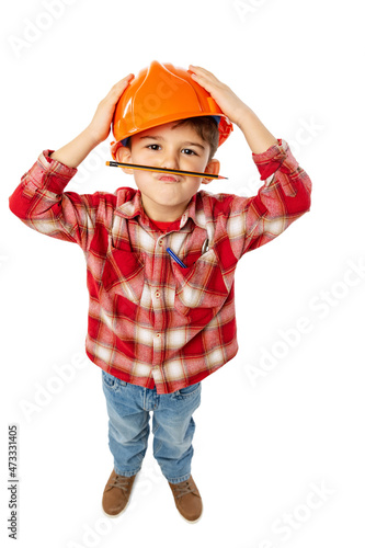 High angle view of funny little boy, kid in image of builder, architect in orange protective helmet isolated on white background photo