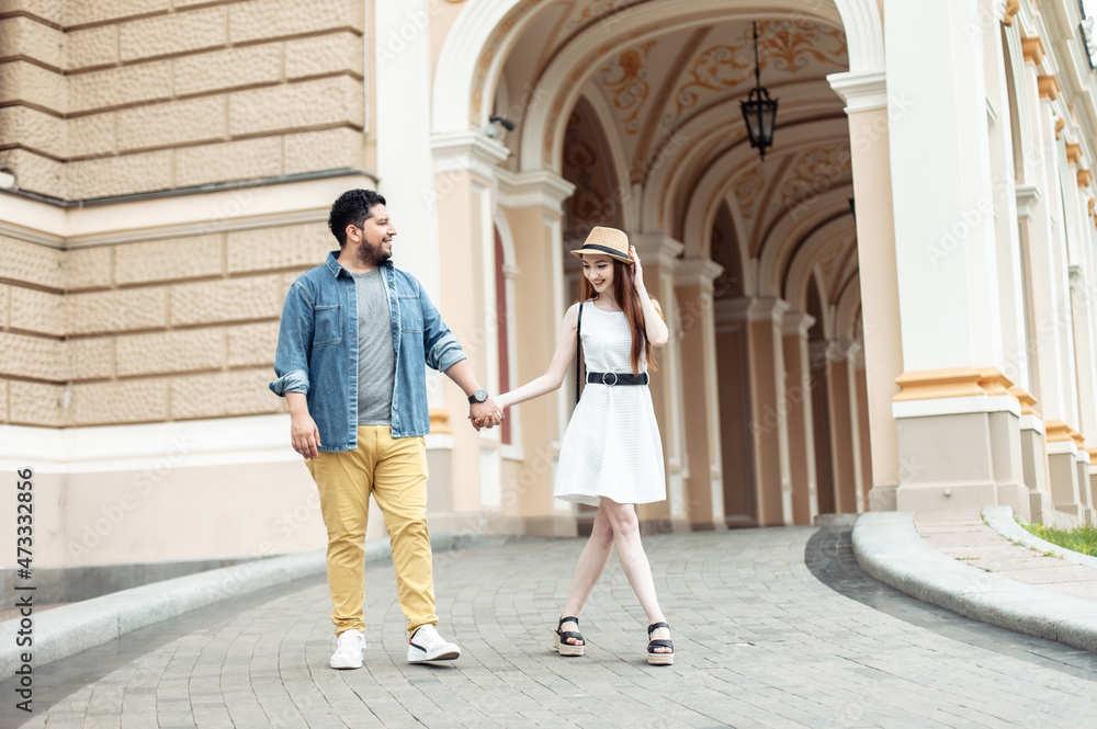 Young international couple in love walking in european city
