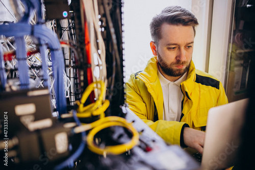 Fotografie Young man engineer making program analyses