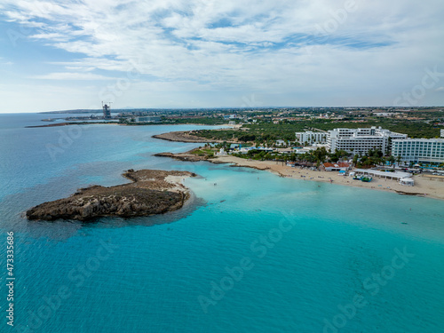Nissi Beach in Ayia Napa, clean aerial photo of famous tourist beach in Cyprus, the place is a known destination on island and is formed from a smaller island just near the main shore © SAndor