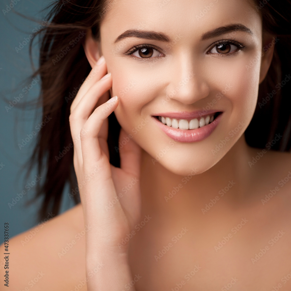 Smiling young woman touching flawless skin Smiling young woman touching flawless skin