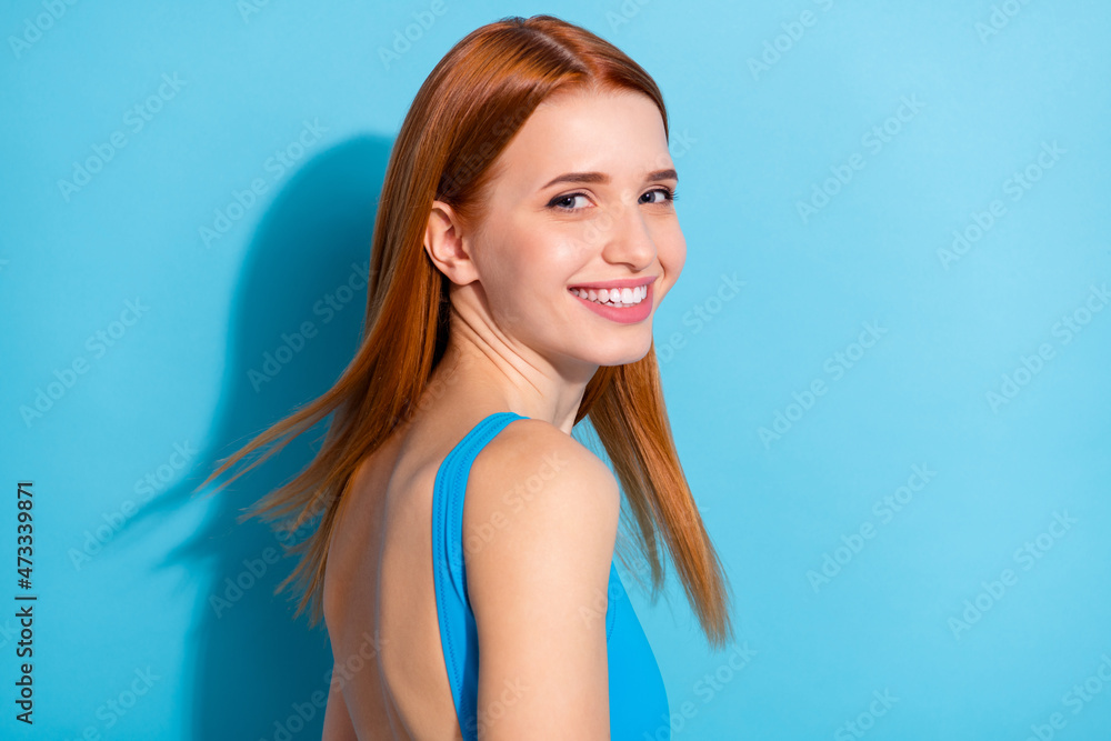 Photo of sweet adorable young lady dressed bodysuit top smiling wind blowing isolated blue color background