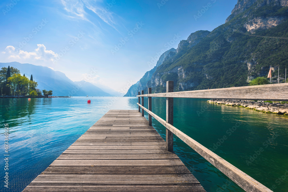 Fototapeta premium Wooden pier on the lake. Riva del Garda, Italy