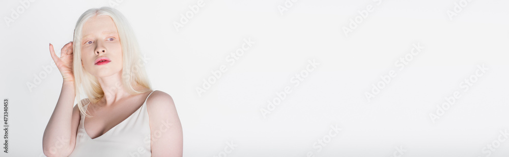 Blonde albino woman holding hand near head isolated on white, banner. Blonde albino woman holding hand near head isolated on white, banner.