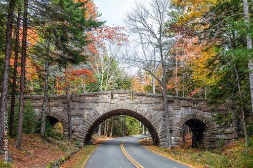 One of the beautiful stone carriage road bridges of Acadia National Park, Mt. Desert Island, Maine, crosses the highway surrounded by beautiful fall foliage color. photo