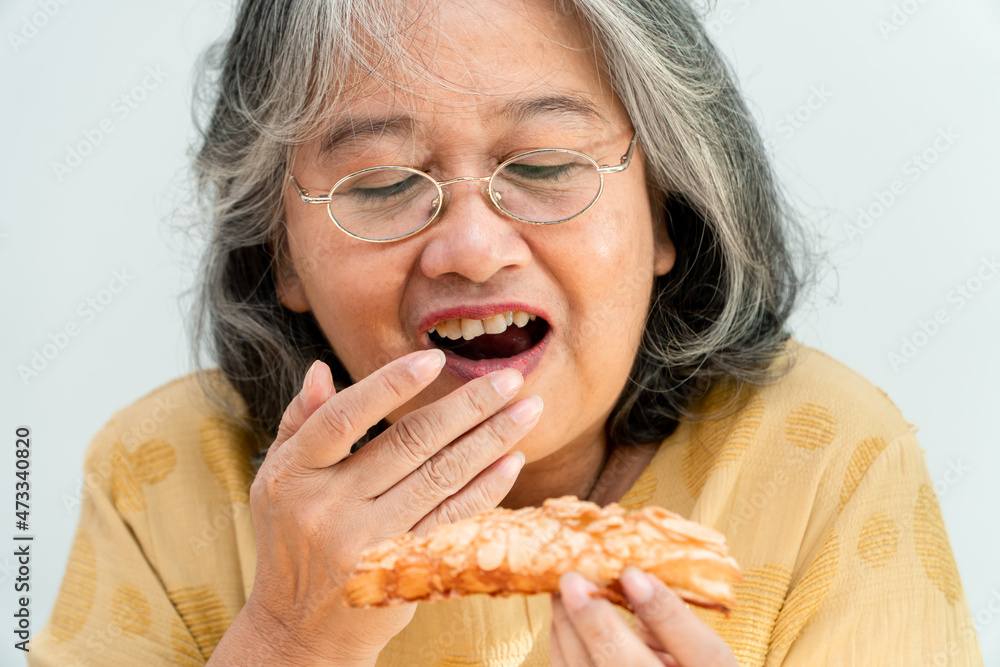 Happy Asian senior women enjoying eating pie