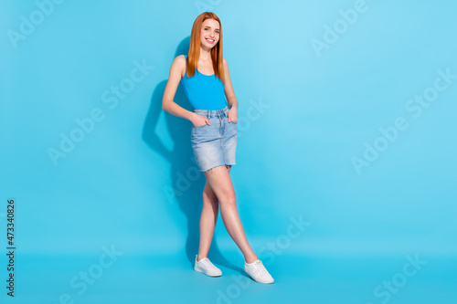 Photo portrait red haired woman in pretty singlet jeans skirt good mood isolated pastel blue color background
