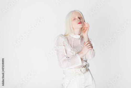 Young albino woman posing isolated on white.