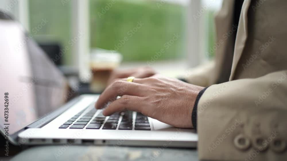 Close up hand young businessman using laptop typing working in cafe Close up hand young businessman using laptop typing working in cafe