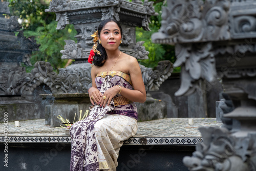 Balinese woman in traditional costume, indonesian girl, hindu temple background, Bali.