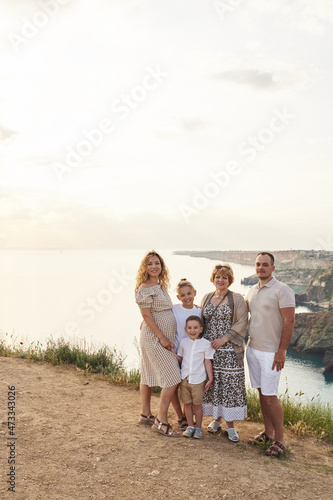 Large family on the background with a beautiful sea view. pregnant mom