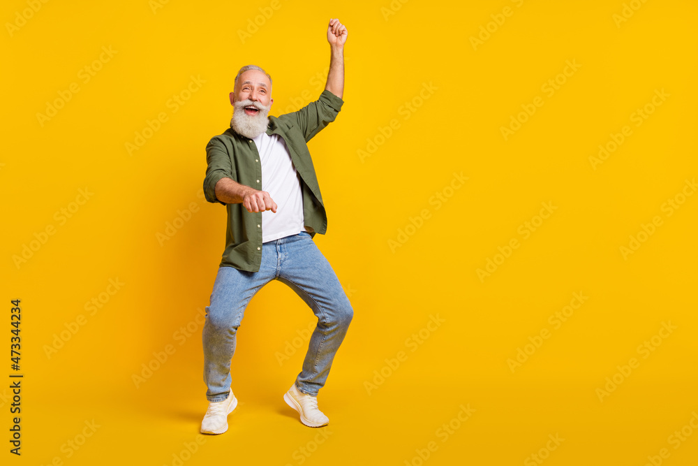 Full length body size photo of senior man crazy imagine riding horse on wild west isolated vivid yellow color background Full length body size photo of senior man crazy imagine riding horse on wild west isolated vivid yellow color background