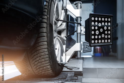 Εκτύπωση καμβά CLose-up car wheel indoors service maintenance repair center against laser sensor equipment diagnostics and 3d wheel alignment