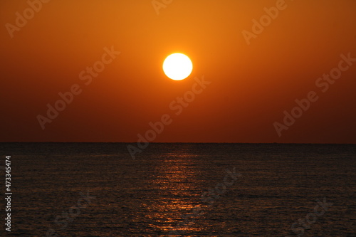 sun disc over blue sea