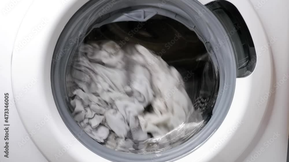 Washing clothes in a washing machine. Washing clothes in a washing machine.