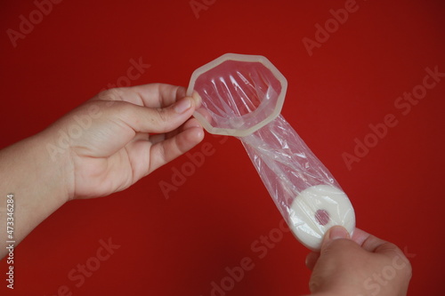 salvador, bahia, brazil - december 6, 2021: Woman holding female condom in Salvador city. photo