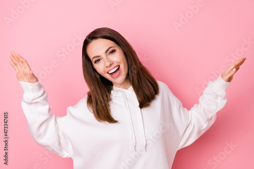 Photo of joyful happy young woman wear casual white hoodie smile enjoy isolated on pink color background