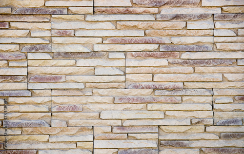 A light brown brick wall background. 