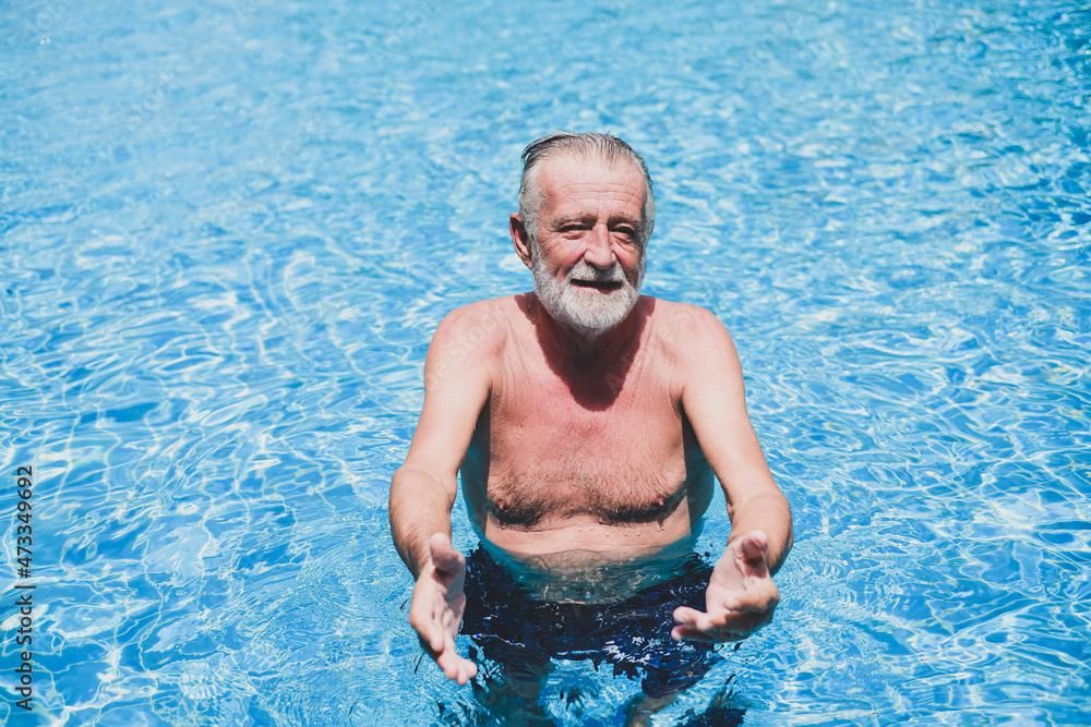 caucasian elder, senior mature man resting in swimming pool