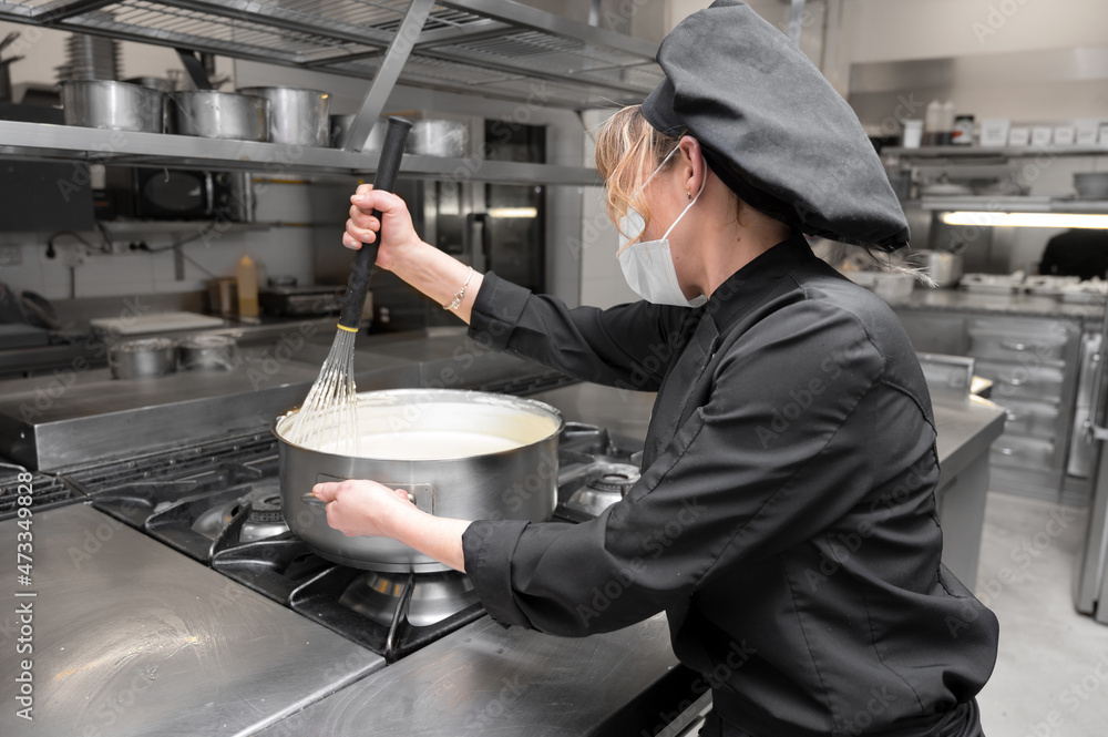 Portrait of a female chef cooking at commercial kitchen. High quality photo Portrait of a female chef cooking at commercial kitchen. High quality photo