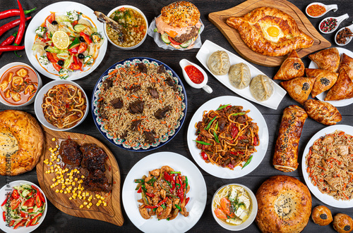 The concept of Eastern asian festive cuisine. Assorted Uzbek food set, pilaf, samsa, lagman, manti, shurpa restaurant concept Eastern arabic new year and Christmas dish from lamb served cookware.