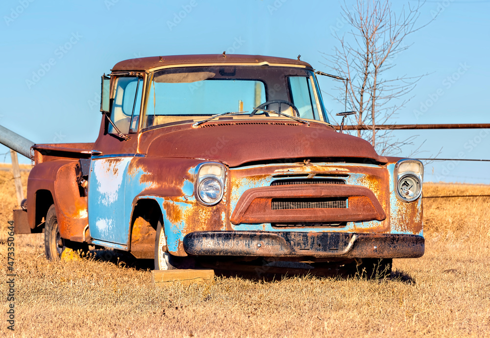 A rusty old classic truck in a farmers field