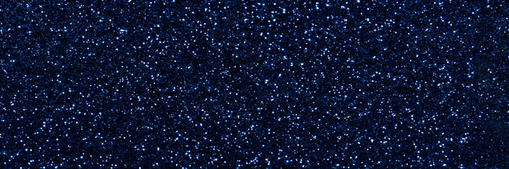 Blue sparkling glitter background, christmas shiny texture. Holiday lights. Abstract defocused header. Wide screen wallpaper. Panoramic web banner with copy space for design