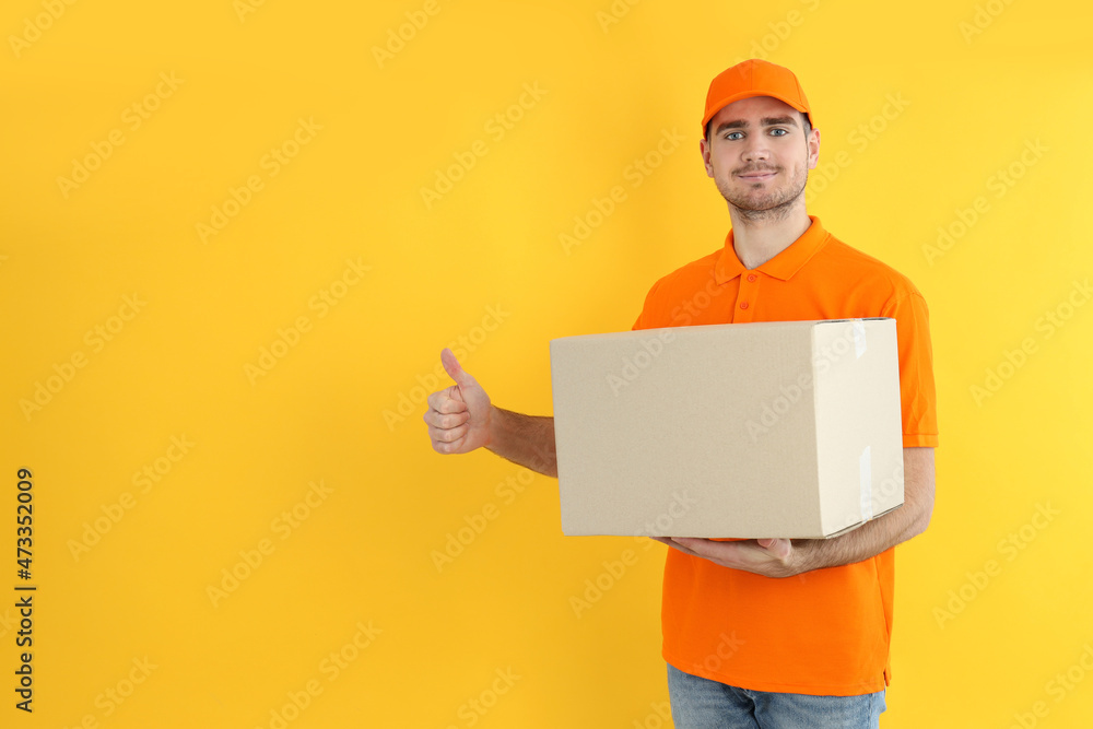 Delivery guy hold box on yellow background