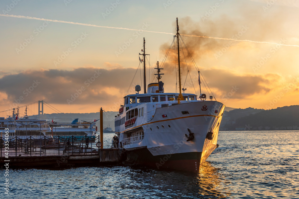 Naklejka premium Ferry is on The Bosphorus at sunrise in Istanbul