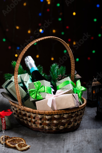 Postcard for the New Year and Christmas. Basket with New Year s gifts. Close-up  selective focus  low key  copy space.
