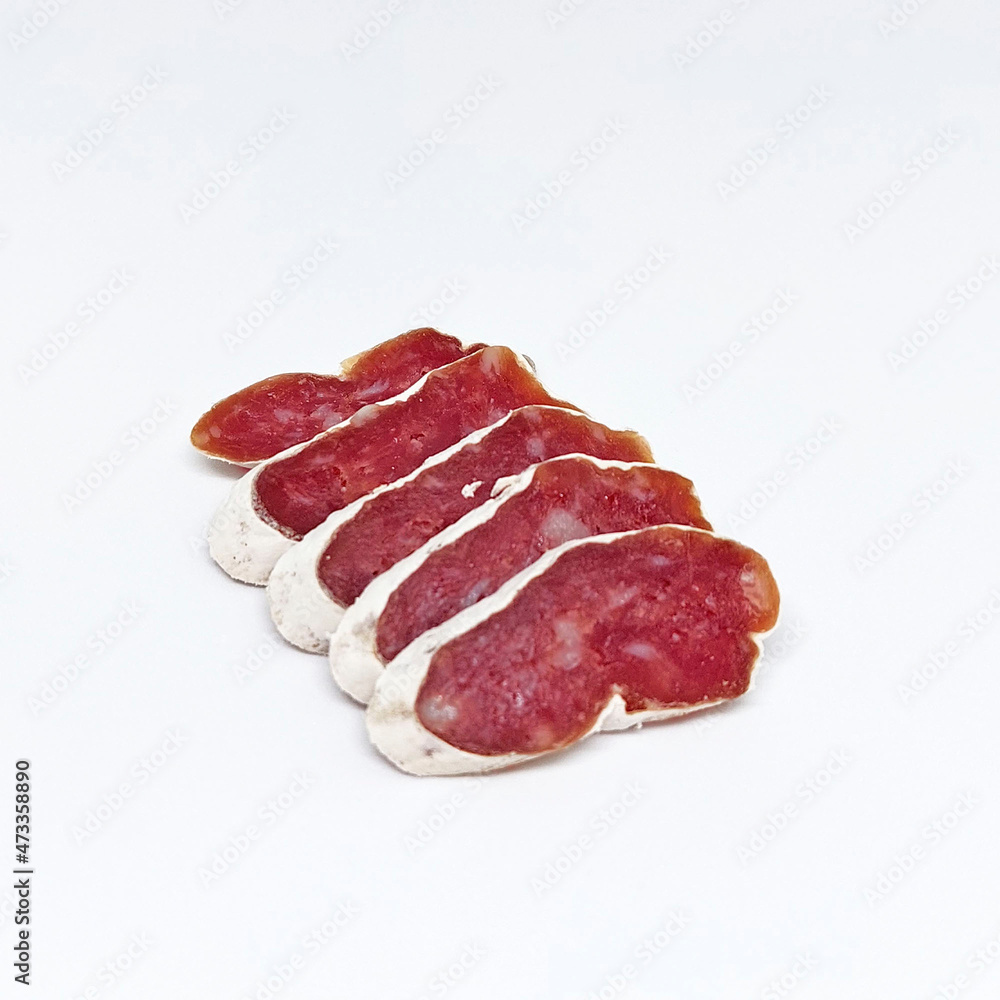 Delicious sliced ​​salami in white mold