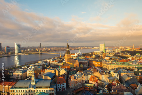 Panorama of the city of Riga on a sunny day  blue sky  morning  sunset  a view of the old town  narrow streets  red brick roofs of houses  cathedrals  a river and bridge.