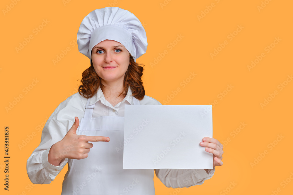 Happy woman chef with blank A4 paper sheet for text in hand on studio background, mockup copy space Happy woman chef with blank A4 paper sheet for text in hand on studio background, mockup copy space