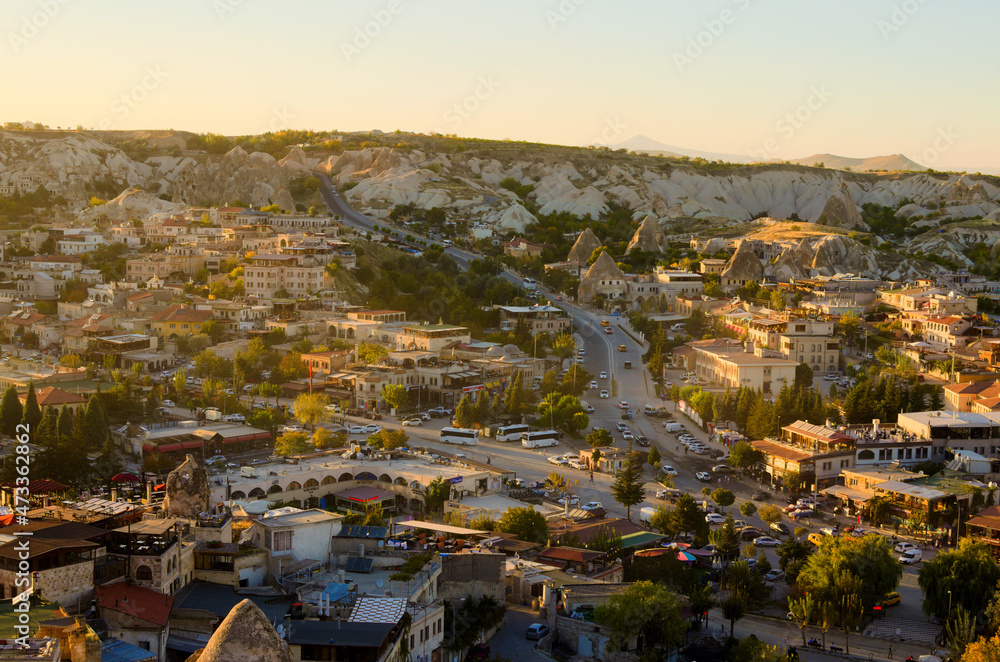 Goreme, Turkey-October 9, 2021:Landscape view of ancient Goreme in during sunset. Amazing cave houses in shaped sandstone rocks. Popular travel destination in Turkey. UNESCO World Heritage Site