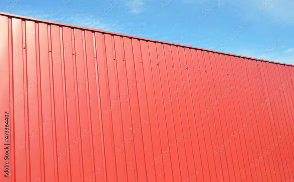 A high red privacy fence from metal profile fence panels. A high red privacy fence from metal profile fence panels.