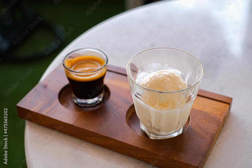 Affogato coffee with ice cream on a glass cup with cafe background, Summer Cocktail.It tastes delicious (close up, selective focus) Affogato coffee with ice cream on a glass cup with cafe background, Summer Cocktail.It tastes delicious (close up, selective focus)