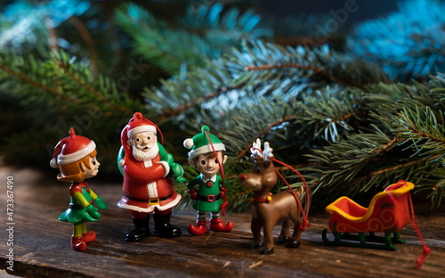Christmas tree decorations. Santa Claus with elves and reindeer. © MLPhoto
