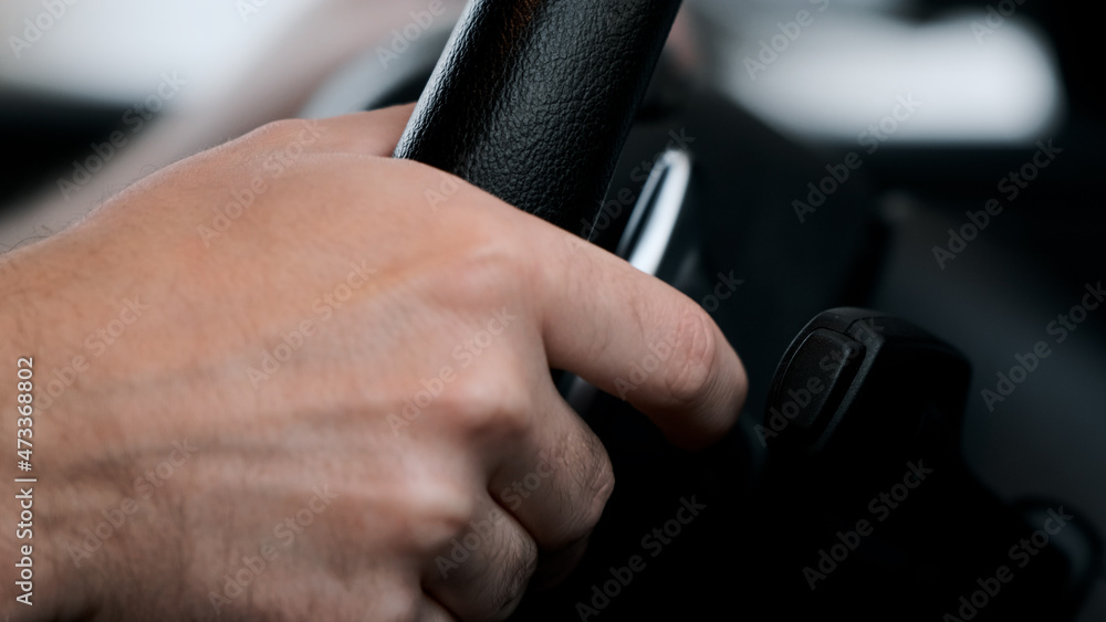 Man shifts gears using the paddles on the steering wheel Man shifts gears using the paddles on the steering wheel