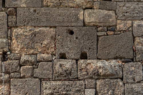 background - antique stone wall made of large blocks of various sizes and shapes