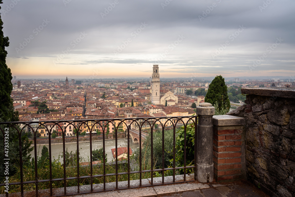 Aerial view of the beautiful city of Verona with the Stone Bridge (Ponte di Pietra) and the Bell Tower from Castel San Pietro at a cloudy sunrise, Veneto region, Italy