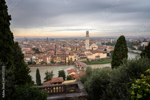 Aerial view of the beautiful city of Verona with the Stone Bridge (Ponte di Pietra) and the Bell Tower at a cloudy sunrise, Veneto region, Italy