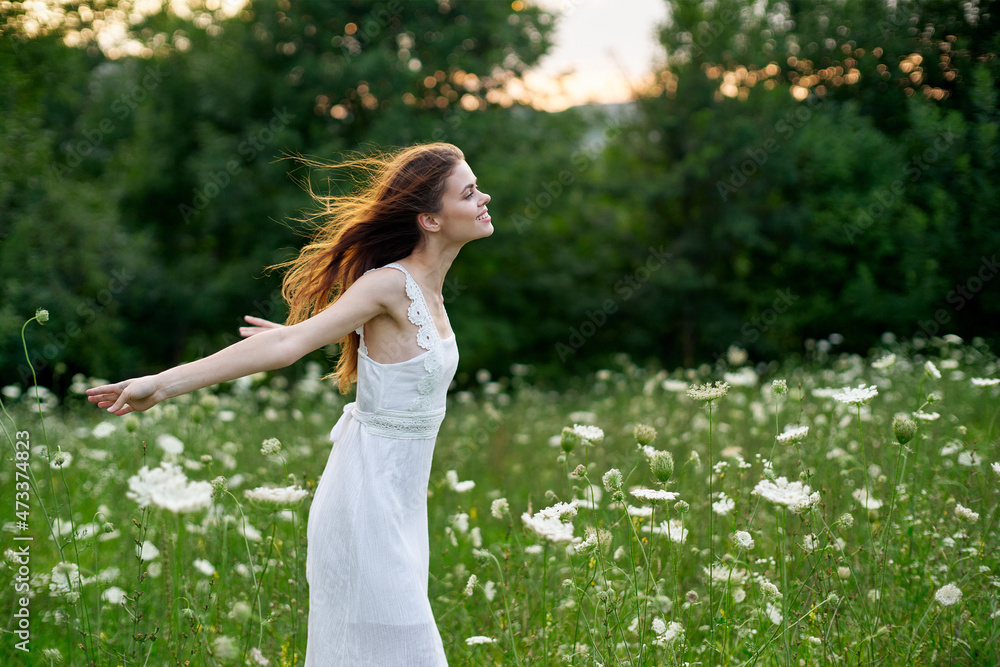 Woman in white dress in a field of flowers walk freedom Woman in white dress in a field of flowers walk freedom