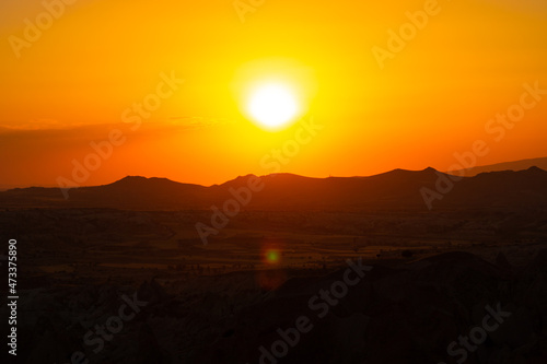 Sunset over the mountains. Sunset scene with silhouettes of mountains