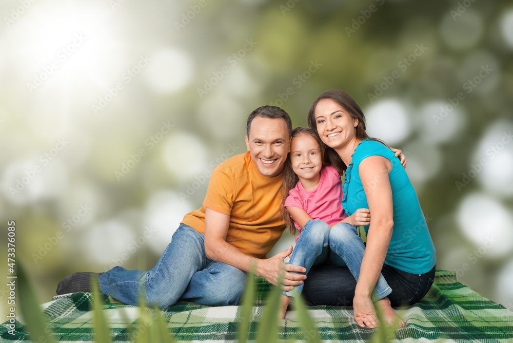 happy family with children having good time sitting on the grass in city park happy family with children having good time sitting on the grass in city park