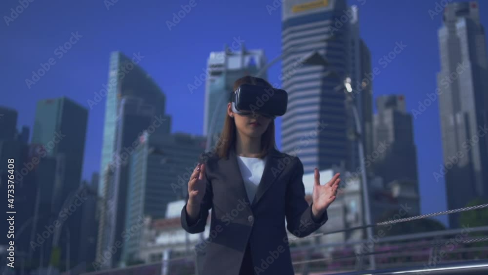 Future is now. Woman using virtual reality device while traveling in Singapore . Future is now. Woman using virtual reality device while traveling in Singapore .