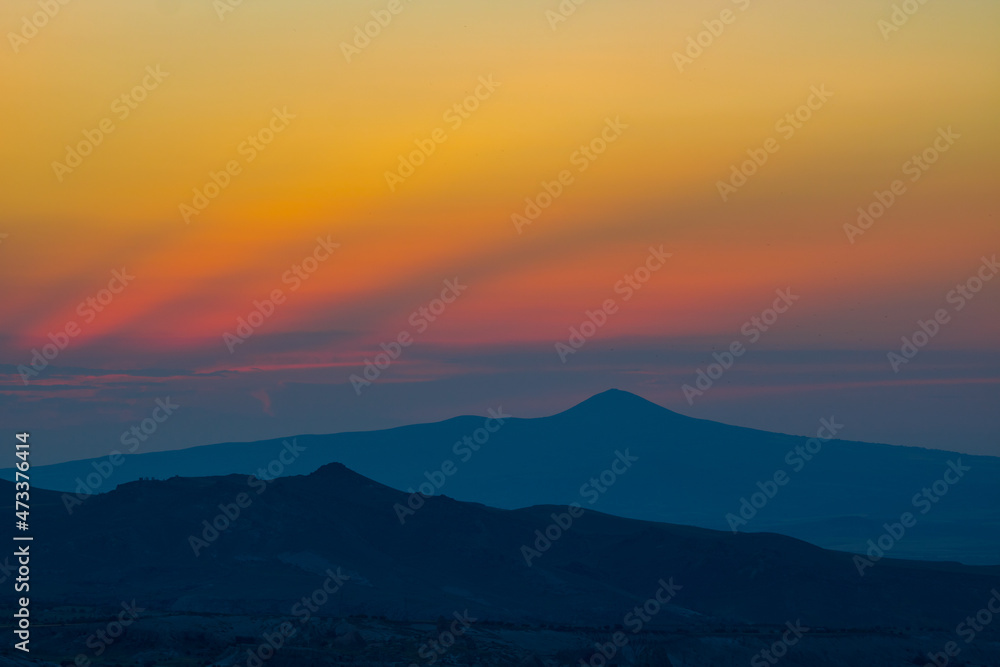 Mountain Peak. Mountain peak and silhouettes at sunset with dramatic clouds